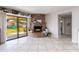 Bright living room with a brick fireplace and sliding glass doors leading to the backyard at 16302 N 36Th Ave, Phoenix, AZ 85053