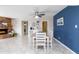 Combined living and dining area featuring a brick fireplace and blue accent wall at 16302 N 36Th Ave, Phoenix, AZ 85053