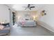 Main bedroom featuring a ceiling fan, comfortable sitting area, and sliding glass door to the outside at 16302 N 36Th Ave, Phoenix, AZ 85053