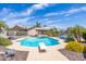 Refreshing swimming pool with diving board, inviting lounge chairs, and beautiful landscaping in a private backyard setting at 16302 N 36Th Ave, Phoenix, AZ 85053