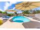 Sparkling swimming pool surrounded by a spacious patio, lounge chairs, and lush landscaping, ideal for recreation at 16302 N 36Th Ave, Phoenix, AZ 85053