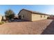 Spacious backyard showcasing a patio area, gravel landscaping, and the home's exterior at 17532 W Bajada Rd, Surprise, AZ 85387