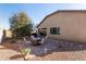 Outdoor fire pit area with seating, surrounded by gravel and mature landscaping at 17532 W Bajada Rd, Surprise, AZ 85387