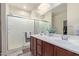 Bathroom featuring double sinks and a glass-enclosed shower at 17532 W Bajada Rd, Surprise, AZ 85387