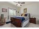 Cozy bedroom with a traditional wood bed frame, neutral walls, and stylish decor at 17532 W Bajada Rd, Surprise, AZ 85387