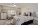 Well-lit bedroom featuring a decorative bed frame and comfortable seating area at 17532 W Bajada Rd, Surprise, AZ 85387