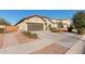 A beautiful single-story home with desert landscaping and an attached two-car garage with a concrete driveway at 17532 W Bajada Rd, Surprise, AZ 85387