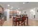 A kitchen featuring stainless steel appliances, granite countertops, a breakfast bar, and a tile floor at 17532 W Bajada Rd, Surprise, AZ 85387