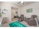 Cozy living room featuring recliner chairs, a ceiling fan, and a view into another room at 17532 W Bajada Rd, Surprise, AZ 85387