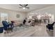 Open concept living room with hardwood floors, neutral walls, ceiling fan, and a view into the kitchen at 17532 W Bajada Rd, Surprise, AZ 85387