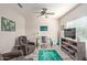 Comfortable living room featuring an inviting chair, ceiling fan, and a well-lit desk area at 17532 W Bajada Rd, Surprise, AZ 85387