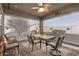 Enclosed patio with a ceiling fan and outdoor seating for dining and relaxation at 17532 W Bajada Rd, Surprise, AZ 85387