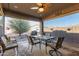 Enclosed patio with a ceiling fan and outdoor seating for dining and relaxation at 17532 W Bajada Rd, Surprise, AZ 85387