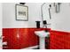 Stylish powder room with red tile, a pedestal sink, and modern fixtures at 19063 N 265Th Ave, Buckeye, AZ 85396