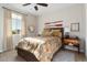 Charming bedroom with floral bedding, a wicker bed frame, and a ceiling fan at 19063 N 265Th Ave, Buckeye, AZ 85396