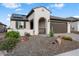 Single story home with arched entryway, solar panels and drought tolerant landscaping at 19063 N 265Th Ave, Buckeye, AZ 85396