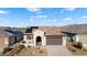 Single-story home with solar panels, desert landscaping, and a 2-car garage at 19063 N 265Th Ave, Buckeye, AZ 85396