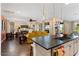 Open kitchen with island, dark countertops, and a view of the living room at 19063 N 265Th Ave, Buckeye, AZ 85396