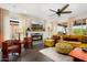 Bright living room with a fireplace, large sectional sofa, and lots of natural light at 19063 N 265Th Ave, Buckeye, AZ 85396