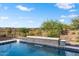 Relaxing pool area with stone feature and lush landscaping at 19063 N 265Th Ave, Buckeye, AZ 85396