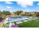 Inviting backyard pool with stone waterfall feature at 19063 N 265Th Ave, Buckeye, AZ 85396