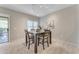 Bright dining room with a dark wood table and four chairs, near sliding door to patio at 19700 N 76Th St # 1112, Scottsdale, AZ 85255