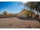 Backyard with gravel landscaping and a covered patio at 201 2Nd E Ave, Buckeye, AZ 85326