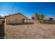 Backyard with gravel landscaping and a covered patio at 201 2Nd E Ave, Buckeye, AZ 85326