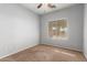 Bright bedroom with carpet flooring, ceiling fan, and window coverings at 201 2Nd E Ave, Buckeye, AZ 85326