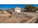 Single-story house with a two-car garage and a side yard at 201 2Nd E Ave, Buckeye, AZ 85326