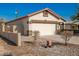 Single-story house with a two-car garage and a side yard at 201 2Nd E Ave, Buckeye, AZ 85326