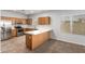 L-shaped kitchen with stainless steel appliances and light wood cabinets at 201 2Nd E Ave, Buckeye, AZ 85326