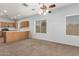 Bright living room with carpet, ceiling fan, and kitchen views at 201 2Nd E Ave, Buckeye, AZ 85326