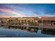 Luxury homes surround a tranquil canal at sunset at 20208 N Oxbow Ln, Maricopa, AZ 85138