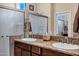 Elegant bathroom with double sinks, granite counters, and a shower at 20208 N Oxbow Ln, Maricopa, AZ 85138