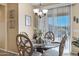 Charming dining area with glass table and four chairs at 20208 N Oxbow Ln, Maricopa, AZ 85138