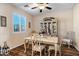 Formal dining room featuring hardwood floors, a charming hutch, and elegant dining set at 20208 N Oxbow Ln, Maricopa, AZ 85138