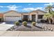 Beautiful desert landscaping around this single-story home with a two-car garage at 20208 N Oxbow Ln, Maricopa, AZ 85138