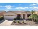 Single story home with attached garage and landscaping at 20208 N Oxbow Ln, Maricopa, AZ 85138