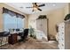 Bright home office features built-in shelving and window coverings at 20208 N Oxbow Ln, Maricopa, AZ 85138