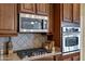 Stainless steel appliances and gas cooktop in this well-equipped kitchen at 20208 N Oxbow Ln, Maricopa, AZ 85138