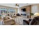 Spacious living room with a stone fireplace and large windows offering natural light at 20208 N Oxbow Ln, Maricopa, AZ 85138