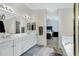 Bathroom featuring double sinks, white cabinets, and access to the main bedroom at 2105 N Kachina --, Mesa, AZ 85203