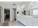 Bright bathroom featuring double sinks, white cabinets, and a walk-in closet at 2105 N Kachina --, Mesa, AZ 85203