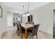 Bright dining room featuring tiled floors, a large table, and six black leather chairs at 2105 N Kachina --, Mesa, AZ 85203