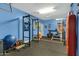 Garage converted to a home gym with weights, stationary bike, and punching bag at 2105 N Kachina --, Mesa, AZ 85203