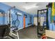 Garage converted to a home gym with weights, punching bag, and weight training system at 2105 N Kachina --, Mesa, AZ 85203