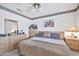 Guest bedroom with king-size bed and wood dresser at 22506 N Mirage Ln, Sun City West, AZ 85375