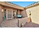 Covered front porch with teal bench, decorative pots, and patterned flooring at 22506 N Mirage Ln, Sun City West, AZ 85375