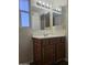 Bathroom with vanity, bright lighting, mirror, and window at 2324 W Luke Ave, Phoenix, AZ 85015